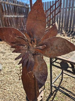 Rustic yard / garden art flower with small rusty table - and a shepherd's hook plant hanger