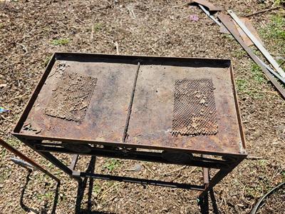 Rustic yard / garden art flower with small rusty table - and a shepherd's hook plant hanger