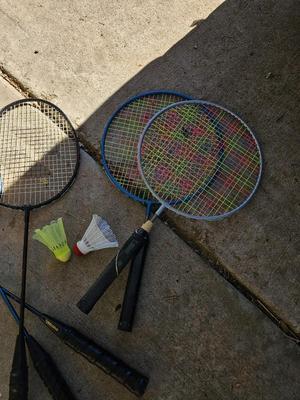 Badminton racquets - birdie - net - and a dart board