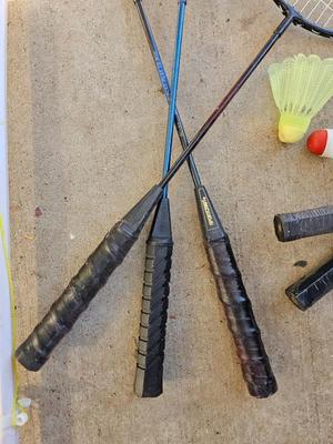 Badminton racquets - birdie - net - and a dart board