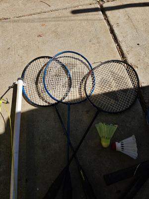 Badminton racquets - birdie - net - and a dart board