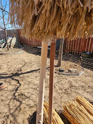 Tiki straw umbrella with stand and three rolls of bamboo wall art