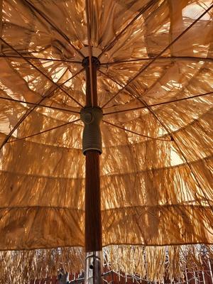 Tiki straw umbrella with stand and three rolls of bamboo wall art