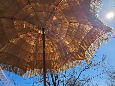 Tiki straw umbrella with stand and three rolls of bamboo wall art
