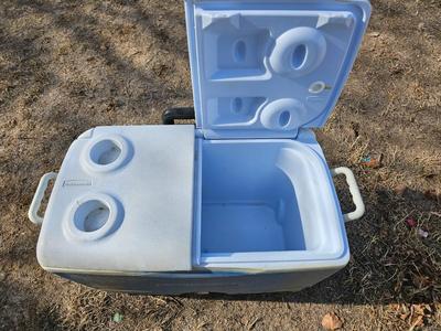 Rubbermaid cooler and a new Coleman griddle and a small umbrella