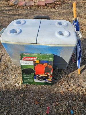 Rubbermaid cooler and a new Coleman griddle and a small umbrella