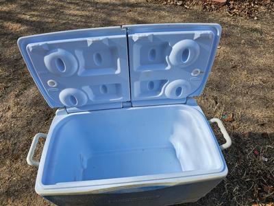 Rubbermaid cooler and a new Coleman griddle and a small umbrella