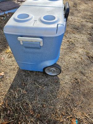 Rubbermaid cooler and a new Coleman griddle and a small umbrella