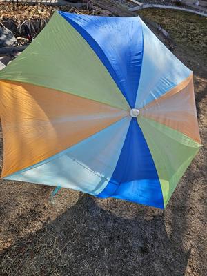 Beach toys with bucket - water noodles - and an umbrella