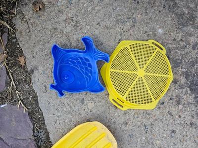 Beach toys with bucket - water noodles - and an umbrella