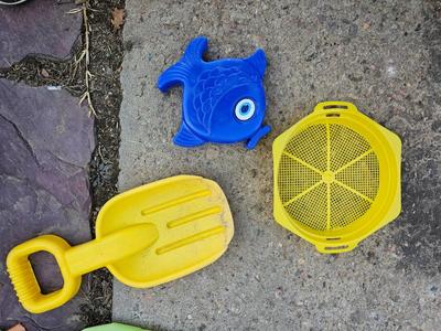 Beach toys with bucket - water noodles - and an umbrella