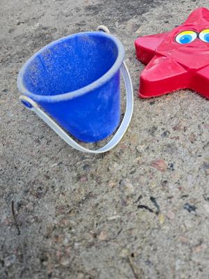 Beach toys with bucket - water noodles - and an umbrella