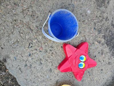 Beach toys with bucket - water noodles - and an umbrella
