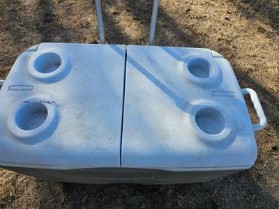 Rubbermaid cooler with folding chair and two fishing rods