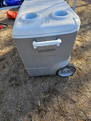 Rubbermaid cooler with folding chair and two fishing rods