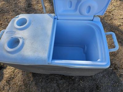 Rubbermaid cooler with folding chair and two fishing rods