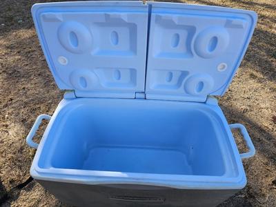 Rubbermaid cooler with folding chair and two fishing rods