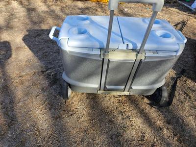 Rubbermaid cooler with folding chair and two fishing rods