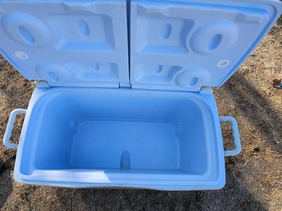 Rubbermaid cooler with folding chair and two fishing rods