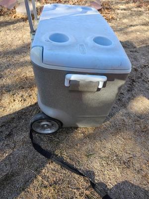 Rubbermaid cooler with folding chair and two fishing rods