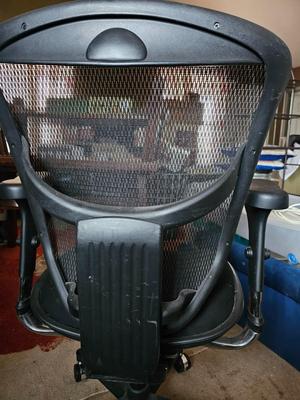 Adjustable ergonomic office chair with old school steel trash can