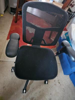 Adjustable ergonomic office chair with old school steel trash can
