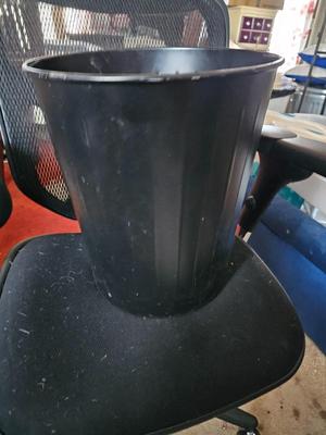 Adjustable ergonomic office chair with old school steel trash can