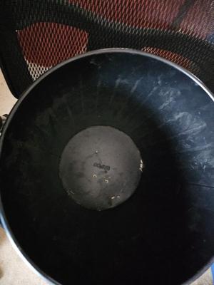 Adjustable ergonomic office chair with old school steel trash can