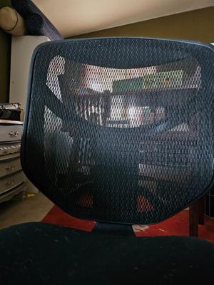 Adjustable ergonomic office chair with old school steel trash can