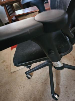 Adjustable ergonomic office chair with old school steel trash can