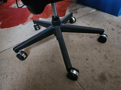 Adjustable ergonomic office chair with old school steel trash can