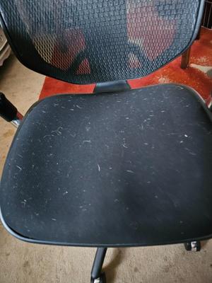 Adjustable ergonomic office chair with old school steel trash can