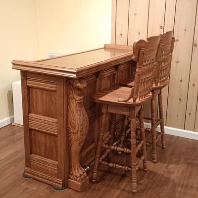 LOT 86B: Vintage Lion Head Oak Bar with Brass Top and Footrest & Set of (2) Swivel Oak Bar Stools