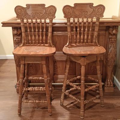 LOT 86B: Vintage Lion Head Oak Bar with Brass Top and Footrest & Set of (2) Swivel Oak Bar Stools