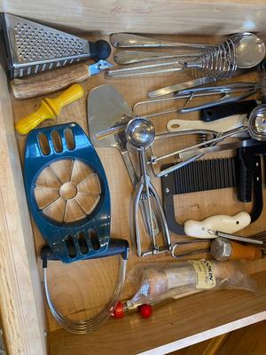 A BUNCH OF KITCHEN DRAWER UTENSILS ITEMS