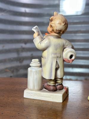GOEBEL HUMMEL "LITTLE PHARMACIST" AND WALKER POTTERY FIGURINES