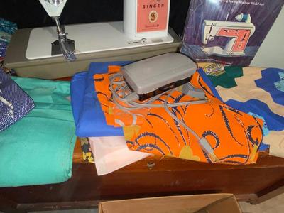 SINGER, SEWING MACHINE IN A VARIETY. OF VINTAGE MATERIAL