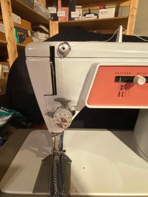 SINGER, SEWING MACHINE IN A VARIETY. OF VINTAGE MATERIAL