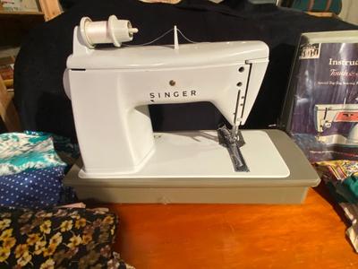 SINGER, SEWING MACHINE IN A VARIETY. OF VINTAGE MATERIAL