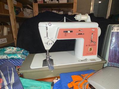 SINGER, SEWING MACHINE IN A VARIETY. OF VINTAGE MATERIAL