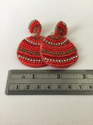 Red beaded circle statement earrings