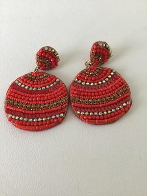 Red beaded circle statement earrings