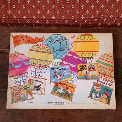 LOT 8: Large Resin Pinocchio Figurine w/ Resin Mickey Mouse Staue and Set of 3 Fairytale Books