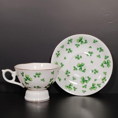 LOT 19: Lefton Shamrock Music Box Teapot and Teacup with O'Dunk 'n' O'Bright Placemats and Mugs & More
