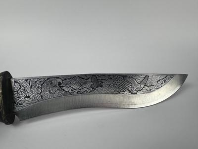 Exquisitely detailed carved 13” American eagle knife with 8” blade with antler stand
