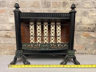 Sale Photo Thumbnail #279: Cast iron gas heater - ceramic bars, copper backing.  And an antique oval frame with lady print