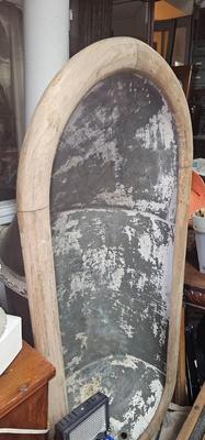 Antique tin bathtub with wood on the edge