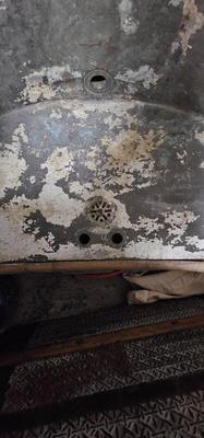 Antique tin bathtub with wood on the edge