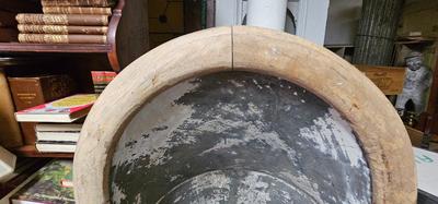 Antique tin bathtub with wood on the edge