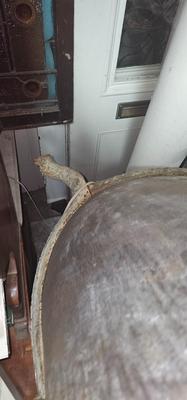 Antique tin bathtub with wood on the edge